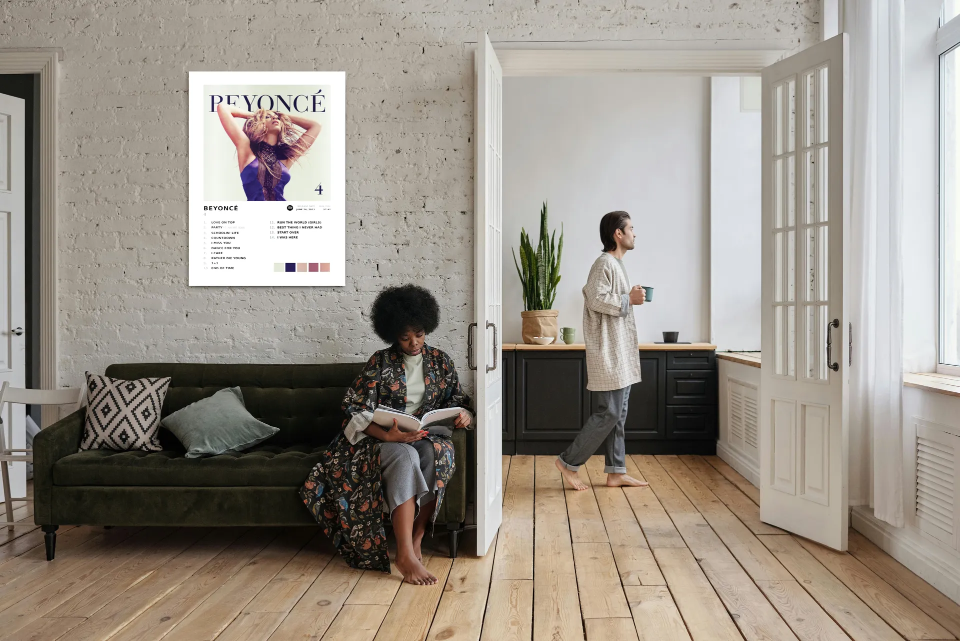 Beyoncé album art metal print on a living room wall with people relaxing at home